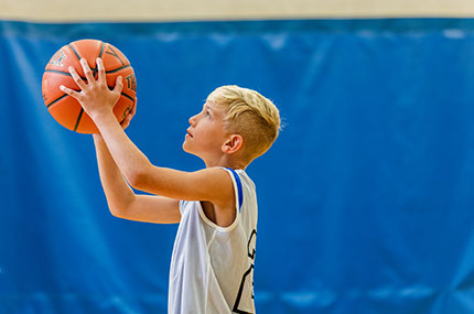 Boy grabs a rebound in youth basketball