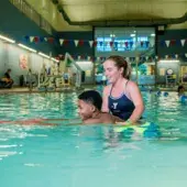 Child and YMCA swim lesson instructor