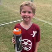 young boy on soccer field