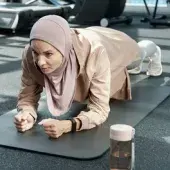 Woman planking in exercise class