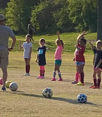 Meredith and team lined up with their soccer balls