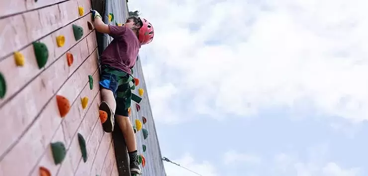 Camper climbs a tower at the Joe C. Davis YMCA Outdoor Center