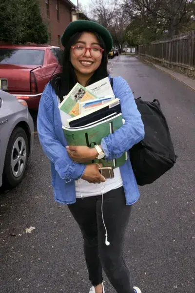 Latino Achievers student holding books