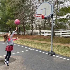 girl shooting a basketball