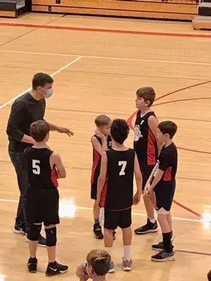 coach talking to his boys basketball team