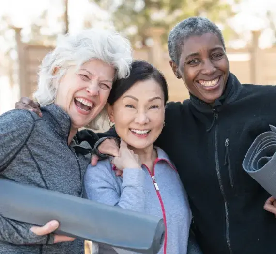 three active older adult women smiling