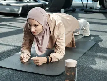 Woman planking in exercise class