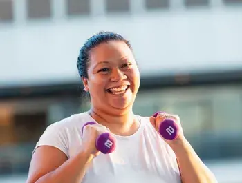 woman smiling with weights