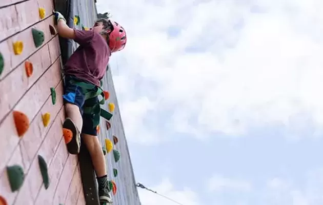 Camper climbs a tower at the Joe C. Davis YMCA Outdoor Center
