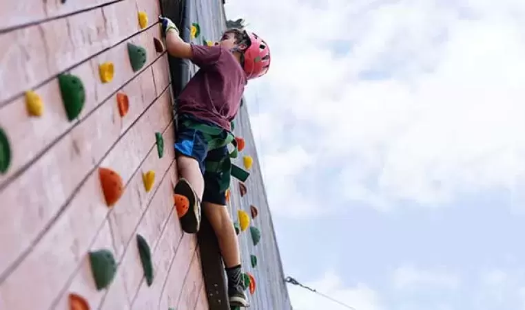 Camper climbs a tower at the Joe C. Davis YMCA Outdoor Center