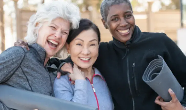 three active older adult women smiling 