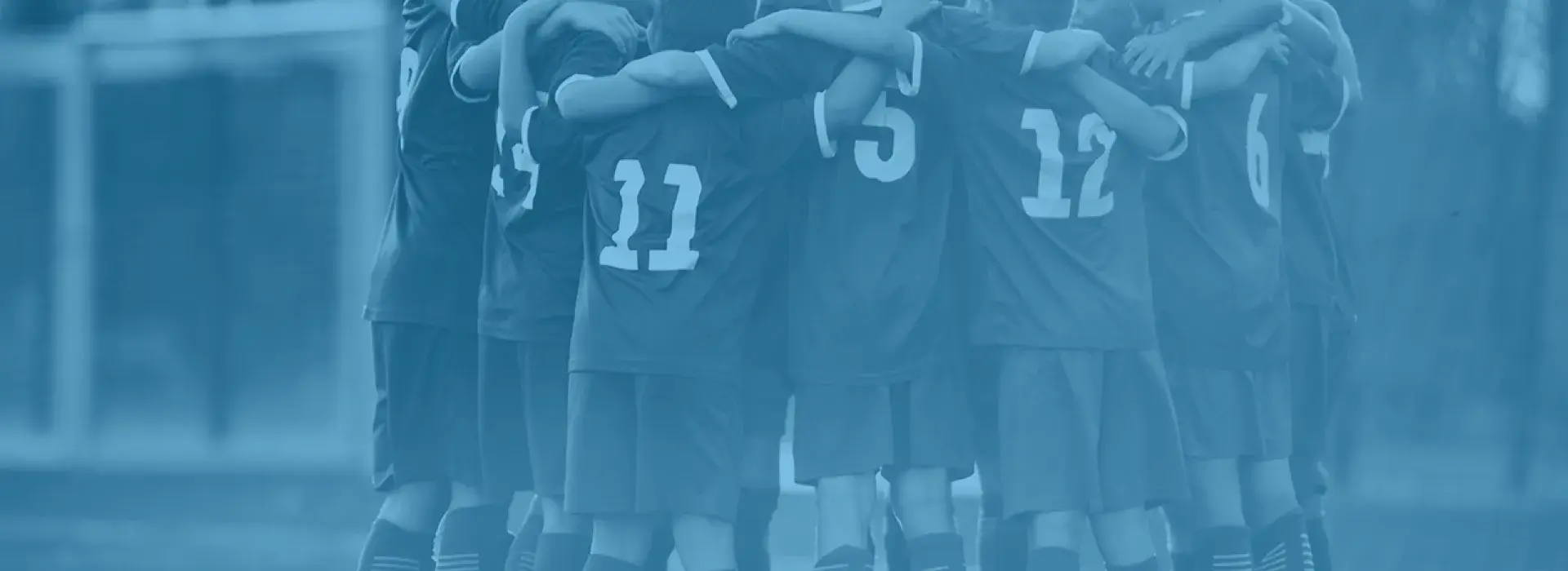 Group of kids huddling before soccer match