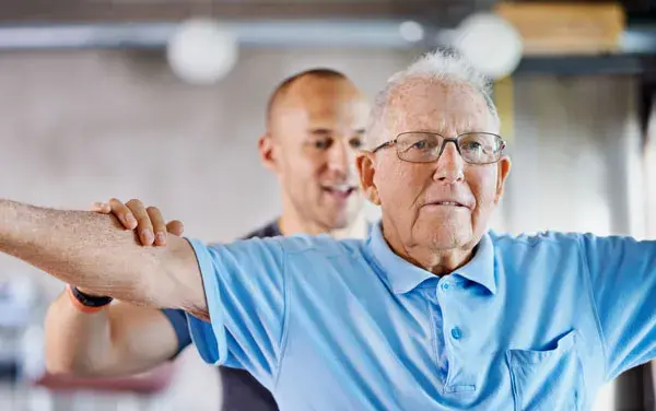 Older gentleman with fitness coach