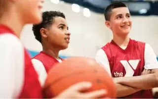 Basketball players listening to coach