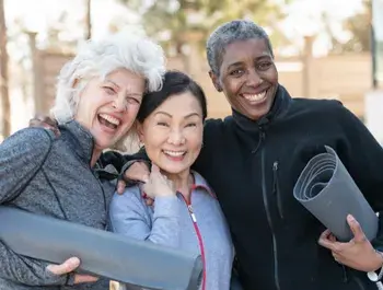 three active older adult women smiling 