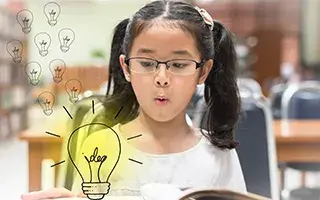 Young girl seeing a cartoon light bulb as she has idea