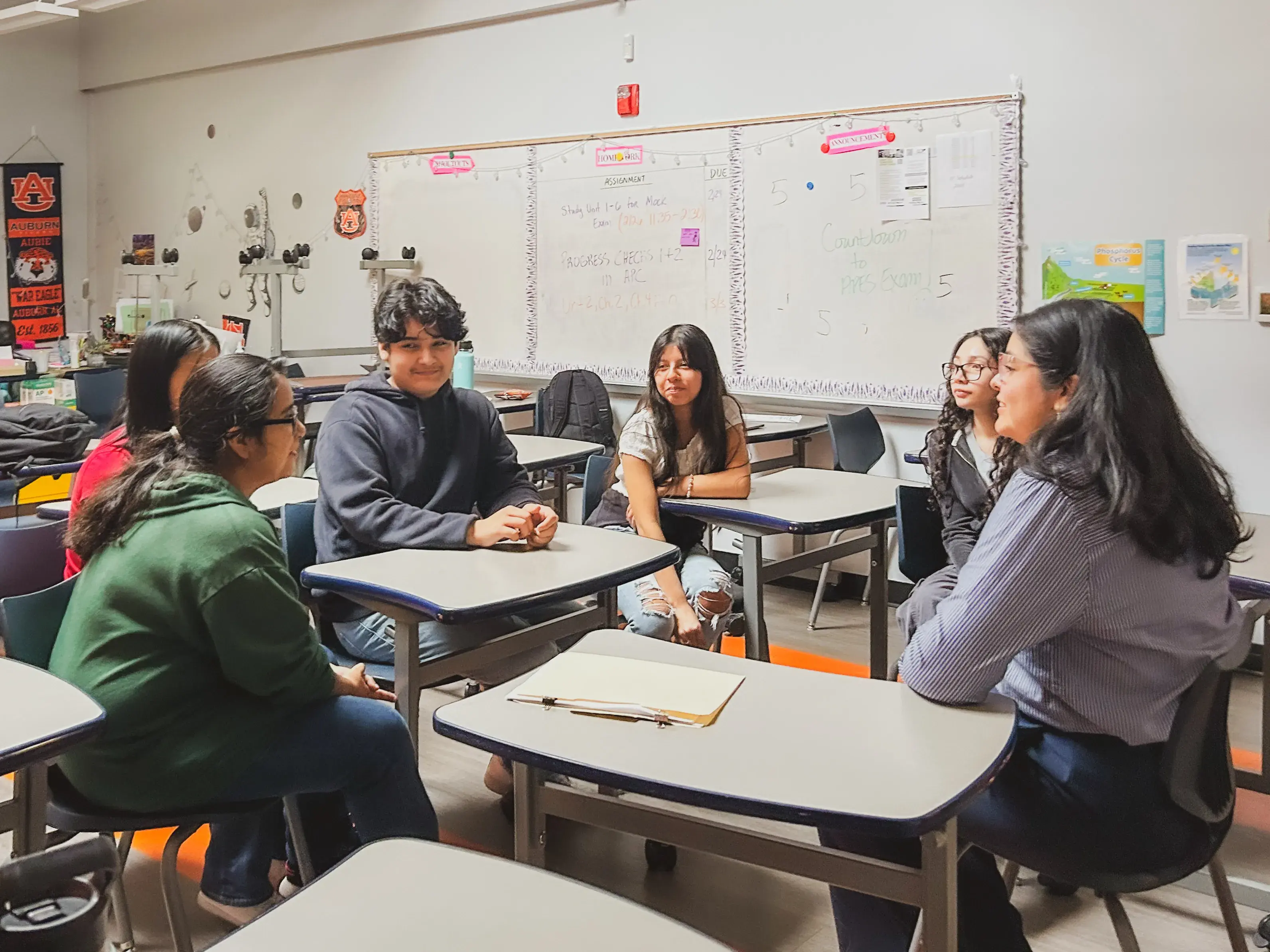 Volunteer speaking with group of students in a classroom
