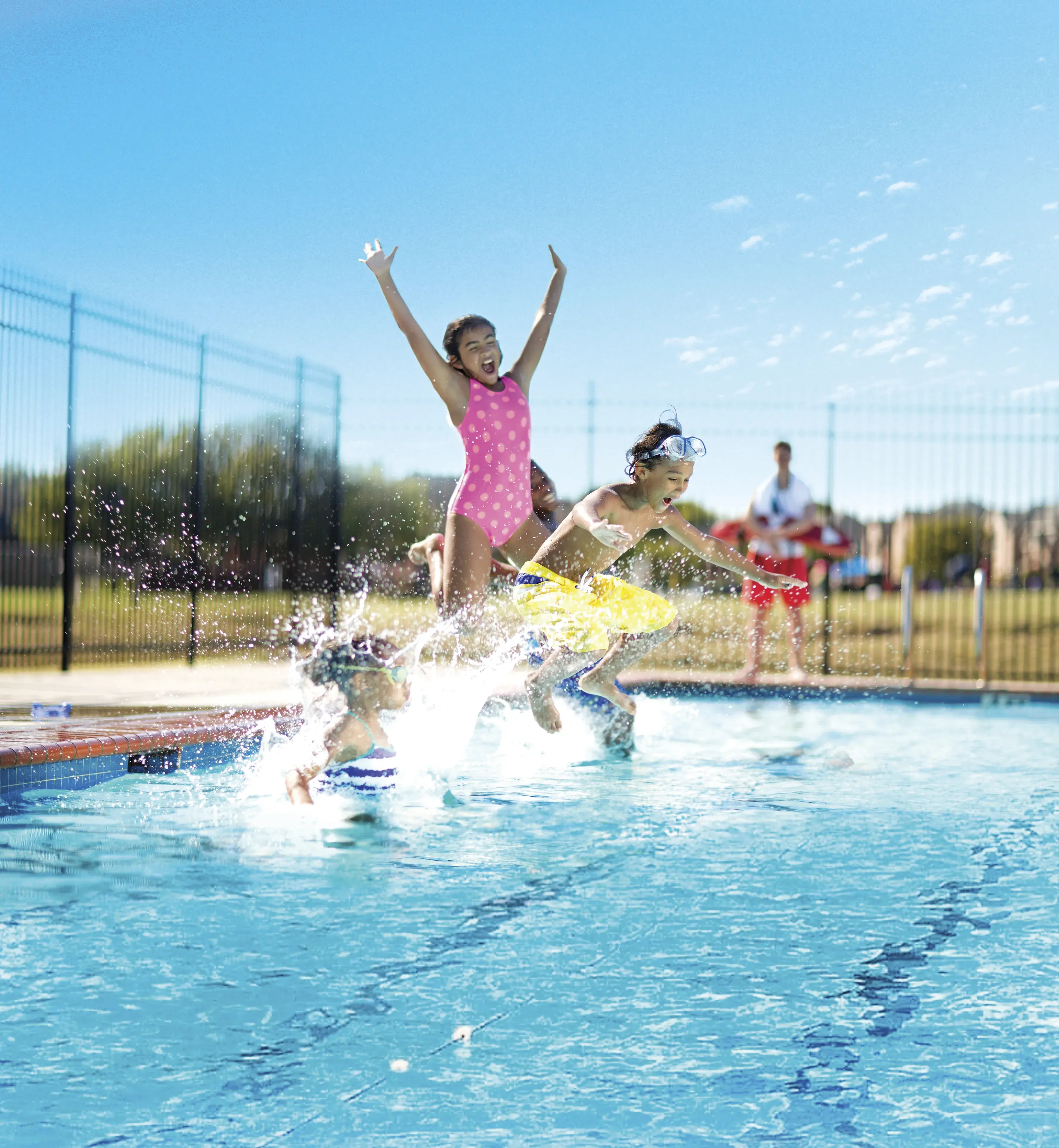 kids jumping into the pool