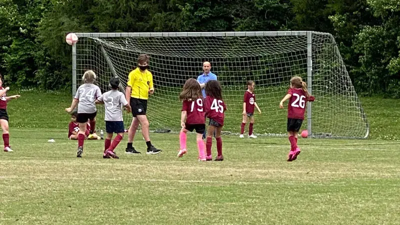 Heather Massie's daughter Meredith plays on the field with her team.