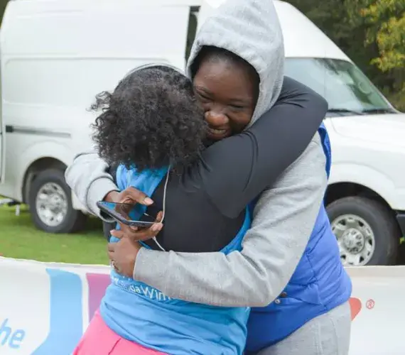 Friends share a congratulatory hug after finishing the race