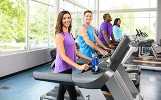 Women posing on treadmill